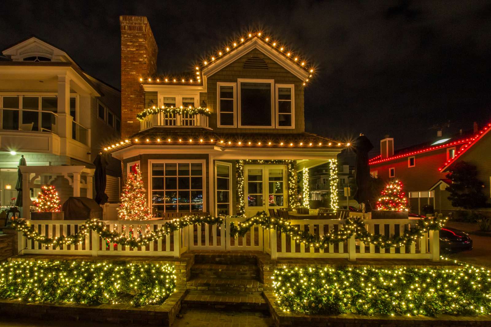 Warm white lights along the edge of a roof at dusk